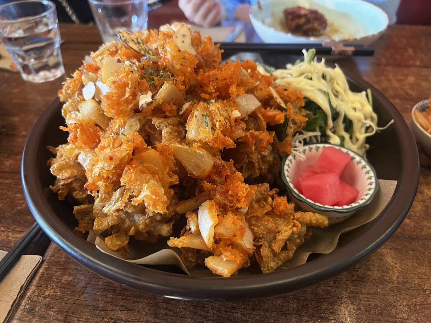 Gganbu crisp fried Korean dish with salad and pickled radish