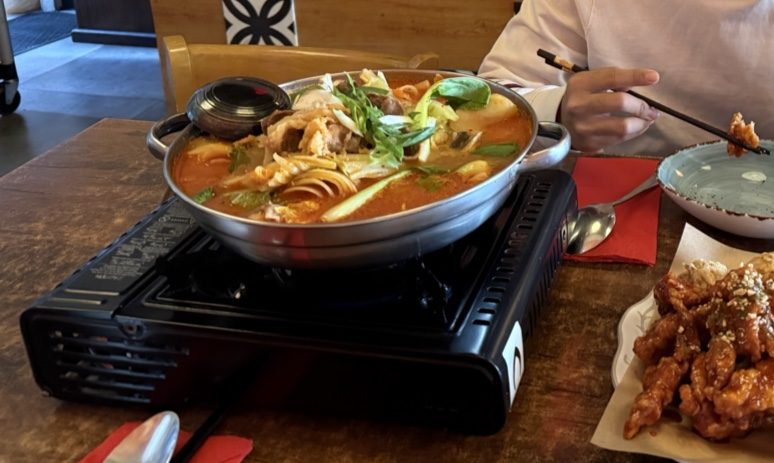Gganbu hot tabletop dish with noodles, vegetables and Korean side dishes